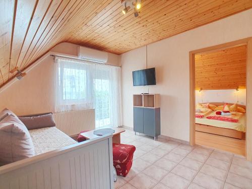 a living room with a couch and a bed at Apartment Anikó Nr 7 in Vonyarcvashegy