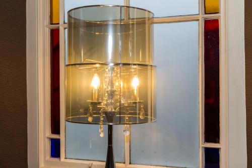 a glass chandelier in front of a window at Jerichos Boutique Accommodation in Windermere