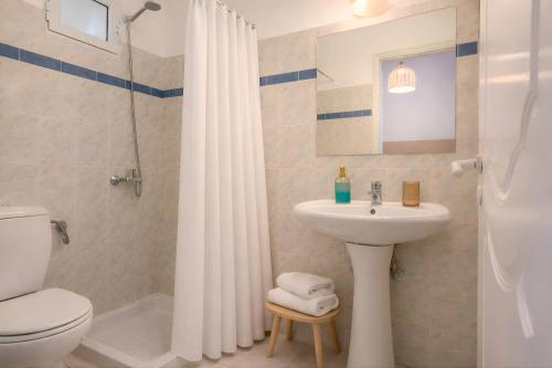 a bathroom with a sink and a toilet and a shower at Nel Mare Studios in Laganas