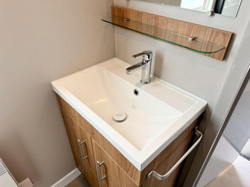 a bathroom with a white sink and a mirror at Chalet Duin & Zee 44, Renesse in Renesse