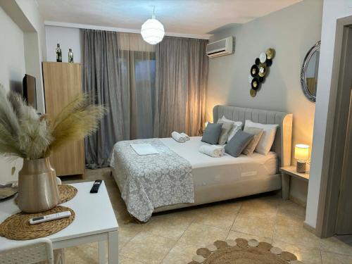 a bedroom with a bed and a table in a room at Luxury Villa Vista in Tsouknída