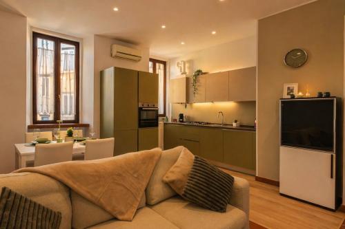 a living room with a couch and a kitchen at Marconi Home in Trieste