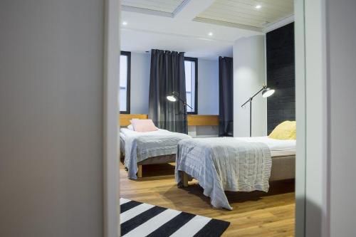 a bedroom with two beds and a window at Hostel Café Koti in Rovaniemi