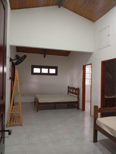 a room with a bed and a table in it at Casa Carlotta in Paracuru