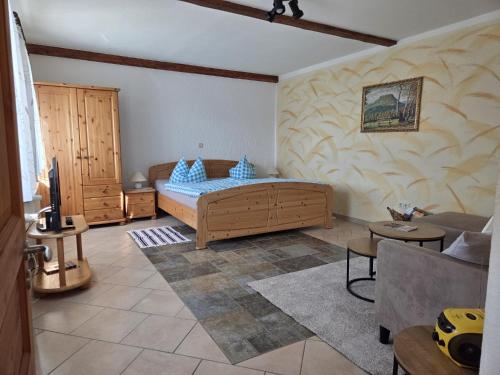 a living room with a bed and a couch at Ferienhaus am Malerweg in Königstein an der Elbe