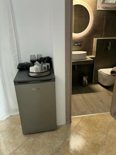 a bathroom with a counter with a sink and a toilet at Luxury Villa Vista in Tsouknída