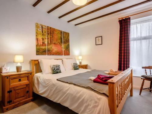 a bedroom with a large bed and a window at 1 Bed in Penrith oc-90417 in Kirkoswald