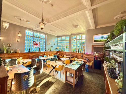 a restaurant with tables and chairs in a room at The Lion Hotel in Builth Wells
