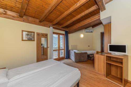 a bedroom with a bed and a television in it at Park Hotel Faver in Tremosine Sul Garda