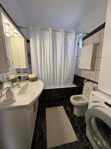 a bathroom with a sink and a toilet at Casa Marianna-Luxury Riviera Retreat in Anavyssos