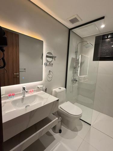 a bathroom with a sink and a toilet and a shower at توليب حتا 2 Tulip Hatta in Al Khobar