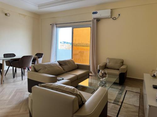 a living room with a couch and a table at Appartements modernes, Wifi, TV - Yaoundé, Omnisports in Yaoundé