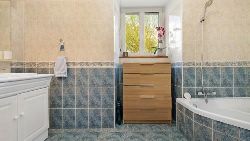 a bathroom with a tub and a sink at Mignonne en lisière de Brocéliande in Mauron