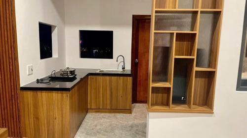 a kitchen with a sink and a counter top at Sun Homestay Doclet in Doc Let