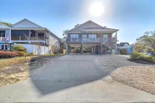 a large house with a driveway in front of it at All Summer Long by Oak Island Accommodations in Oak Island
