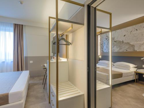 a room with two bunk beds and a desk at Hotel Bologna Airport in Bologna