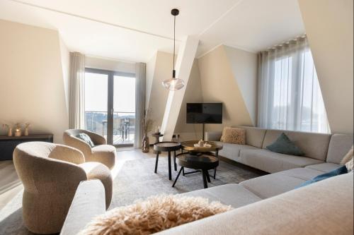 a living room with a couch and chairs and a tv at Astenblick Apartments Winterberg with sauna in Winterberg