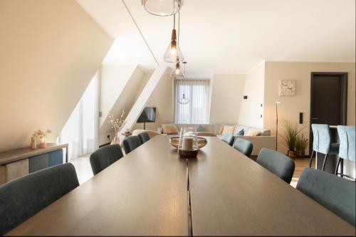 a dining room and living room with a table and chairs at Astenblick Apartments Winterberg with sauna in Winterberg