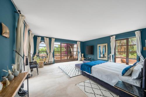 a bedroom with blue walls and a large bed at Villa Socar - Heated pool - Padel - Marrakech in Najem