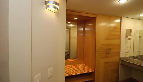 a bathroom with a walk in shower next to a mirror at 1601 - Hotel & Residence Sol Alphaville Flat in Barueri