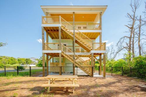 a house with a staircase and a picnic table at All Sands On Deck by Oak Island Accommodations in Oak Island