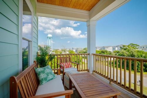 a porch with two benches and a table at All Sands On Deck by Oak Island Accommodations in Oak Island