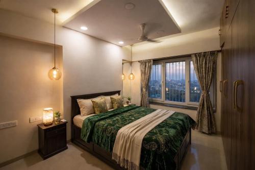 a bedroom with a bed and a large window at Pet Friendly Spacious 3 BHK Penthouse in Mumbai