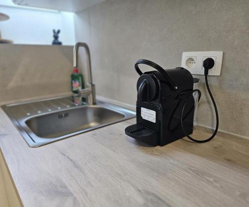 a black backpack sitting on a counter next to a sink at Atomium Apartment 2 in Brussels
