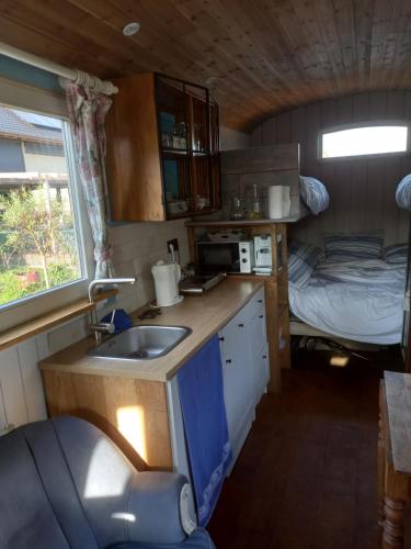 a kitchen with a sink and a bed in a room at Casa Otium in Genk