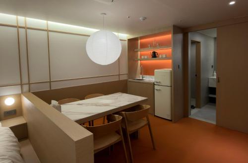 a kitchen and dining room with a table and chairs at Hotel Inspiroom Jongro in Seoul