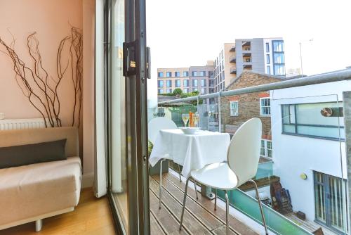 a balcony with a white table and chairs on it at Fabulous Apartment Central London in London