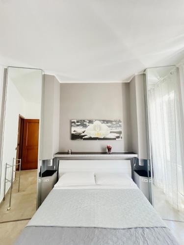 a bedroom with a large bed with a mirror at Scabi Apartments in Trapani
