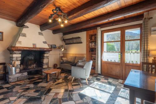 a living room with a fireplace and a couch at Gîte de la Séoube in Campan