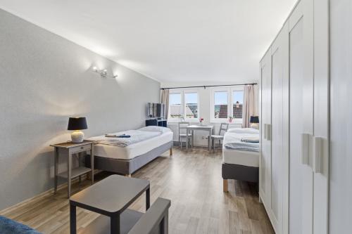 a room with two beds and a table and chairs at Apartmán Plasy in Plasy
