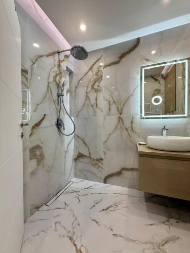a bathroom with a marble shower and a sink at Luxury Apartment Sofia in Sofia