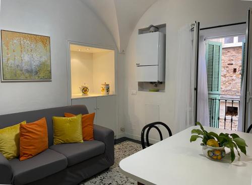 a living room with a couch and a table at Old Town Lemon Charm in Bordighera