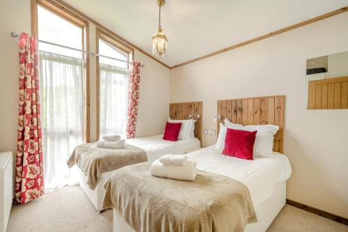 two twin beds in a room with windows at 3 Bed in Whitby oc-wa057 in Runswick