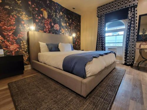 a bedroom with a large bed with a floral wallpaper at The Crescent Hotel Beverly Hills in Los Angeles