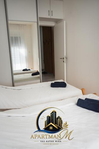 a hotel room with two beds and a mirror at ApartmanMFoca in Foča