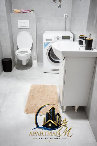 a bathroom with a sink and a washing machine at ApartmanMFoca in Foča