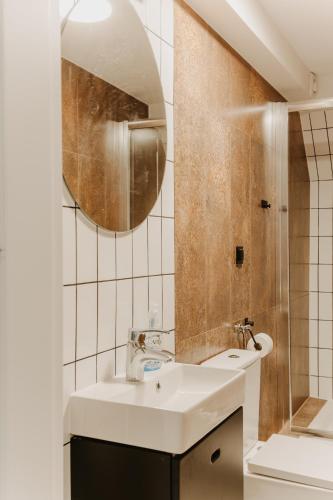 a bathroom with a sink and a mirror at Schronisko PTTK Pod Muflonem in Duszniki Zdrój