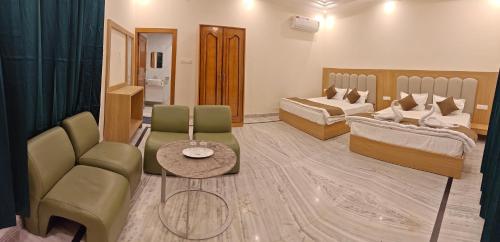a living room with two beds and a couch at Blue Breeze in Haridwār