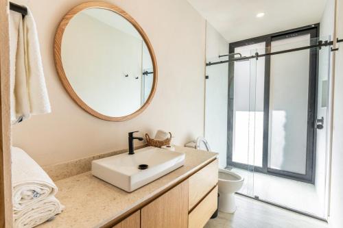 a bathroom with a sink and a mirror at Casa Ambar Luxury Lake View Villa Pool Design in San Juan Cosalá