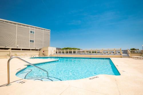 a large swimming pool in front of a building at Beach Therapy by Oak Island Accommodations in Caswell Beach