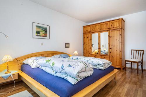 a bedroom with a bed with a wooden frame at Adlerhorst in Wangen