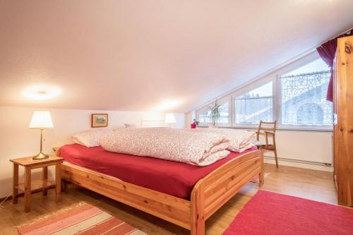 a bedroom with a bed and a large window at Adlerblick in Wangen
