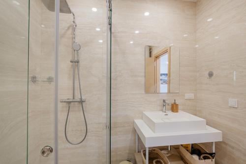 a bathroom with a sink and a shower at River side apartment B17 in Herceg-Novi