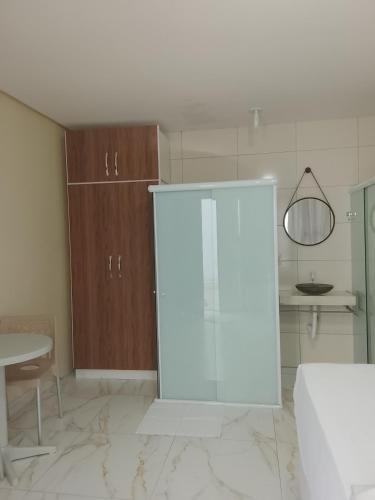 a white cabinet in a room with a table at Cantinho do sol in Maceió