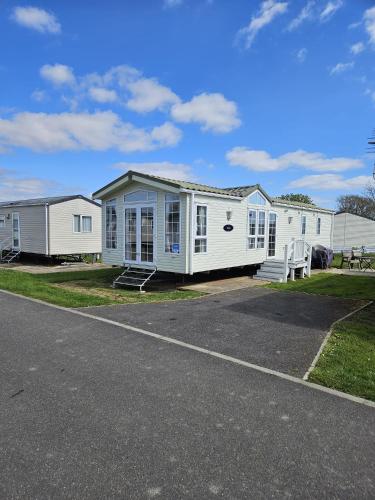 a row of mobile homes on the side of a road at Hampton's Retreat, Haven Church Farm in Pagham