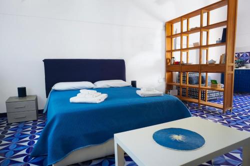 a bedroom with a blue bed with towels on it at A casa di Gennarino in Cetara